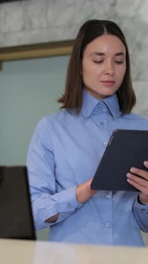 Vertical Video Woman Manager in Formal Outfit Holding Digital Tablet at Work in Hotel Professional