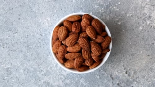 Raw and peeled almonds as a healthy food ingredient. Almonds as a food background