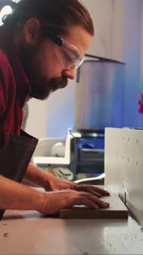 Vertical Video Manufacturer and Apprentice Performing Tasks on Wood Shaper