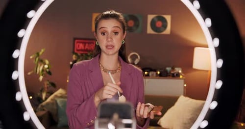 Woman Recording Makeup Tutorial with Ring Light