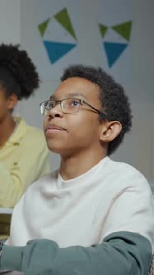 Young Student Attentively Listening in Classroom Setting