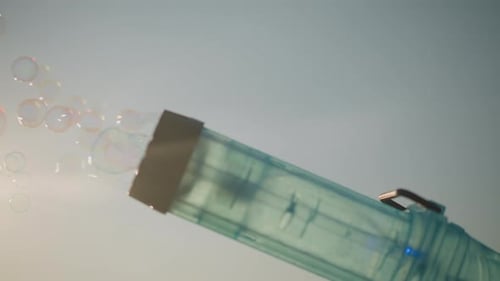 Toy Bubble Gun Blowing Bubbles Outdoors
