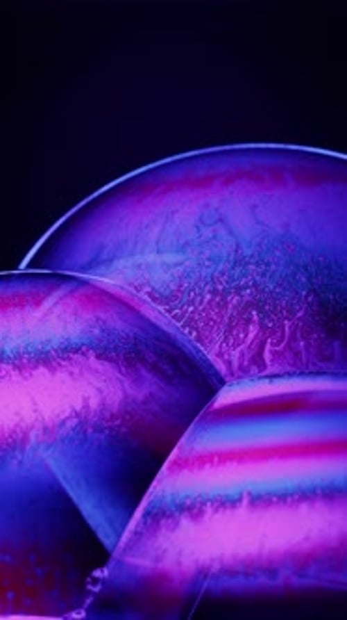 Close-Up Of Pink And Blue Iridescent Soap Bubbles