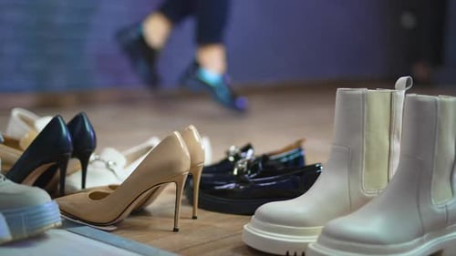Close up view of shoes on the floor. Slow motion lifestyle stylish footwear.