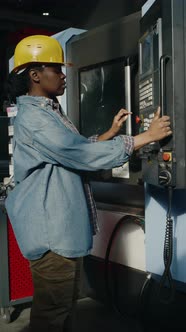 Female Machine Operator Using Control Panel on Industrial Equipment at ...