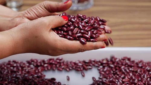 Woman's Hands Sifting and Dropping Kidney Beans