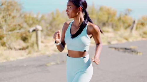 Running, sports and woman on mountain in action for exercise, marathon training