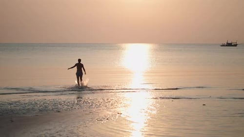 Man Running on Beach at Sunrise or Sunset