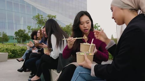 Multiracial business people taking a break eating a meal outside the office