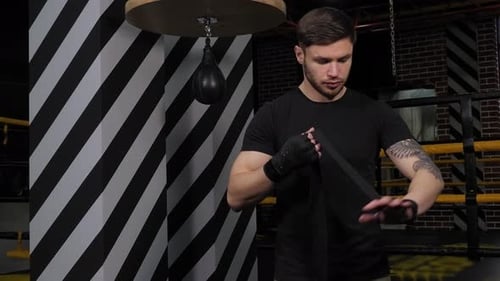 Man Winding Bandage on the Wrists Preparing for Boxing
