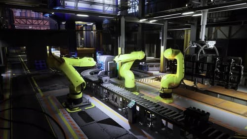 Robotic Arms Operate on an Assembly Line in a Modern Manufacturing Facility