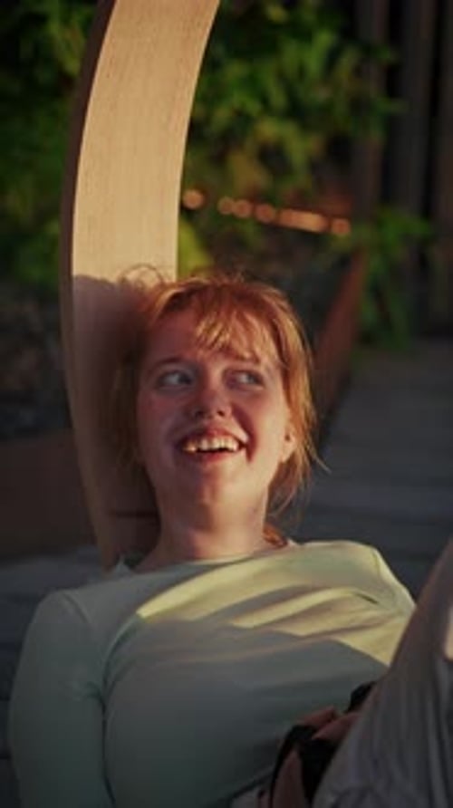 Teen Photographer Relaxing On Swing Chair While Taking Photos