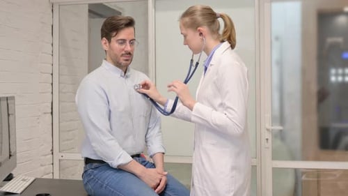 Doctor Examines Male Patient with Stethoscope