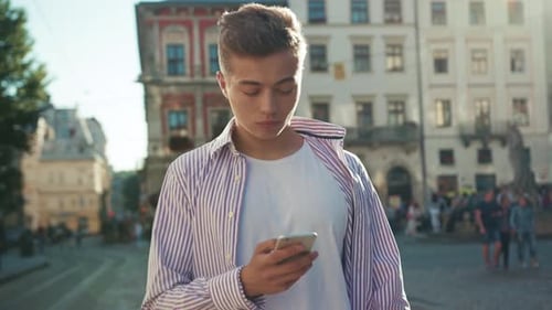 Slow Motion Serious Face Young Serious Man Stand on Street Use Phone Look at Camera Sunlight Work