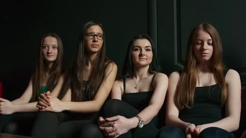 Four Young Women Sitting Together on a Couch