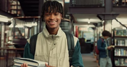 Excited, man and face of student in library for education, learning or studying for university exam