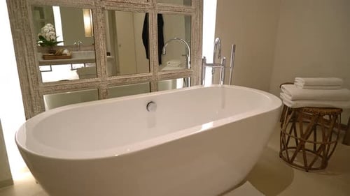Modern Bathroom with White Bathtub and Rustic Mirror