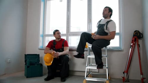 Men Workers Having a Break and Eating Cheesy Roll and