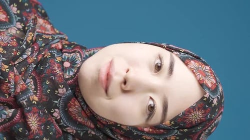 Vertical Video of Innocent and beautiful Muslim Asian woman in hijab smiling.