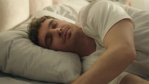 Man Lying on Bed Relaxing With Cell Phone