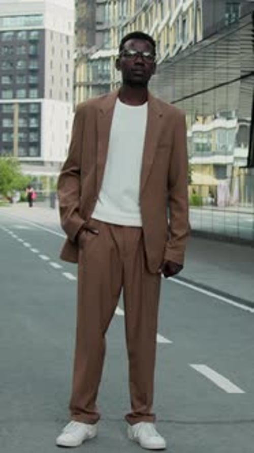 Fashionable Person in Brown Suit Standing in City