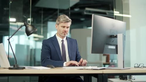 Excited Businessman Celebrating Success in a Modern Office