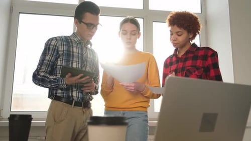 Young Adults Collaborate in a Modern Workplace