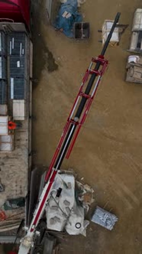 Aerial View of Boom Unloading Windows From Truck