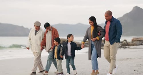 Family, walking on beach and holding hands, generations and travel by the ocean