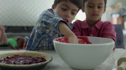 Curious Grandsons Tasting Cherry Pie Filling Watching Grandmother Baking in Kitchen 45 Years