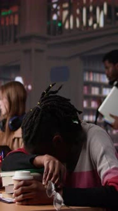 Vertical Video Young Adult Wakes Up Black Student in University Library After Falling Asleep