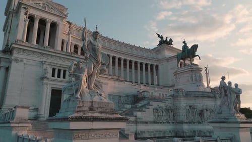 Aerial view of sunlit statues in front of the Altar of the Fatherland, sunny evening in Rome, Italy