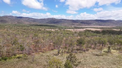 Drone flying to Mount Emerald wind farm. Sustainable green energy produced in Australia.