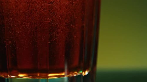 Still Life with Cognac Stock clipOrange Background with a View of an Alcoholic Carbonated Drink and
