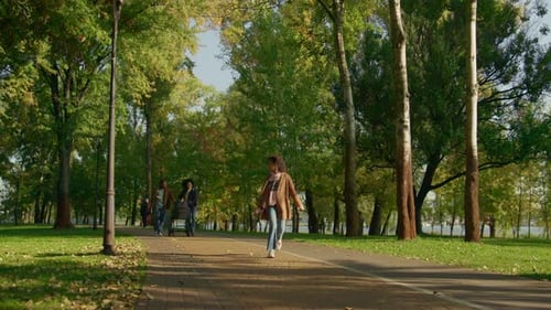 Happy Family Walking Park Together on Sunny Warm Evening. Joyful Girl Jumping