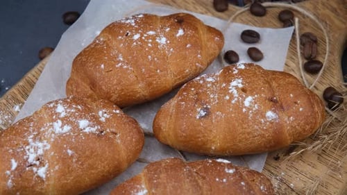 Freshly Baked Croissants with Coffee Beans on Wood