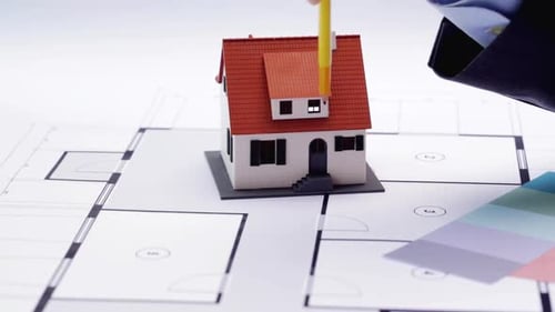 Architectural Planning with Model Home and Blueprints