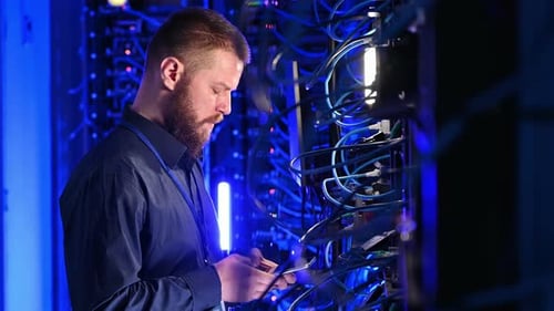 Man Working with Servers in Dark Room
