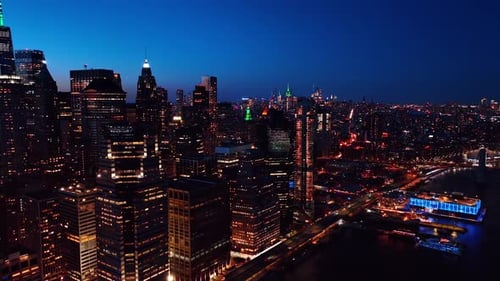 Multiple lights in the windows of Manhattan buildings.