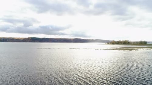 Bird Eye View Quiet Lake with Little Islands and Cloudy Sky