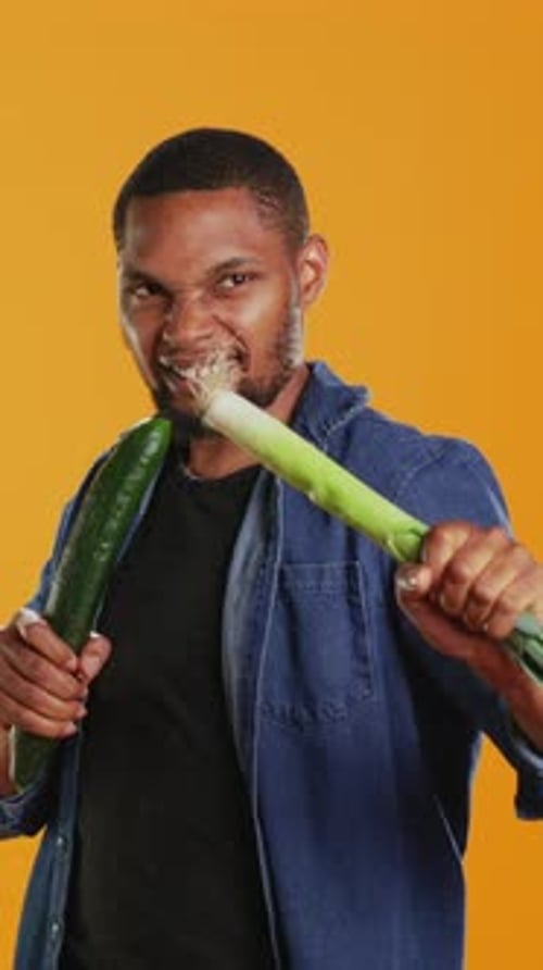 Man Plays with Vegetables as Fencing Weapons