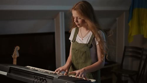 Slow Motion In a Music School a Girl with Long Hair is Intently Playing a Synthesizer