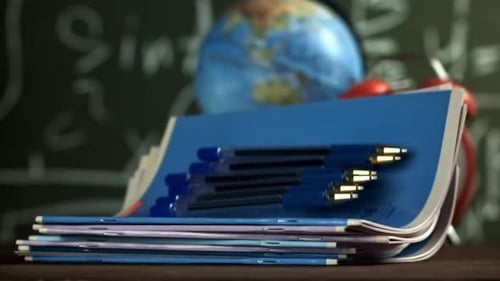 Notebooks and Pens Fall on the School Desk Filmed on a Highspeed Camera at 1000 Fps