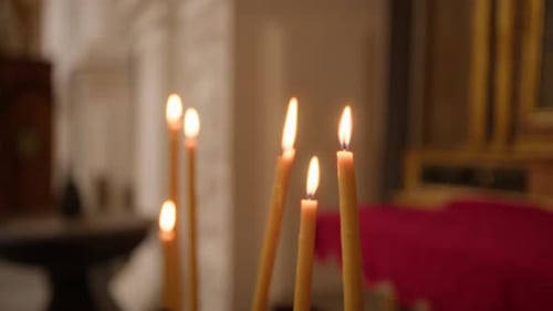 Sacred Candles with Flame in a Christian Church