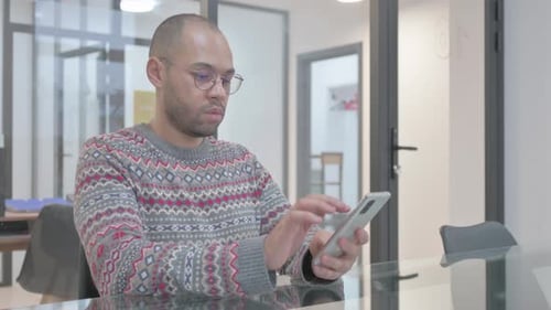 Man Receives Good News on Phone Indoors