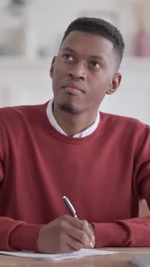 African Man Having Failure while Writing on Paper in Office, Vertical Video