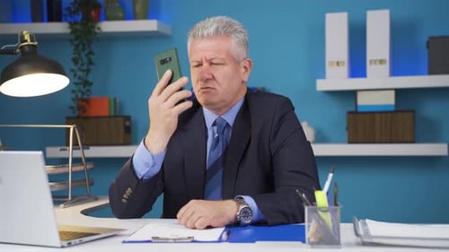 Frustrated Man On Phone Call In Office