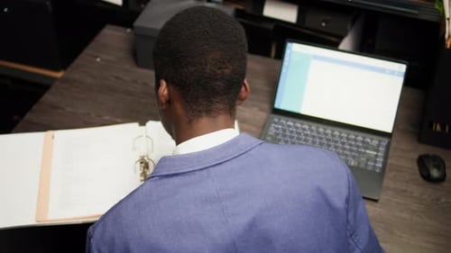 Office Worker at Desk with Computer and Paperwork