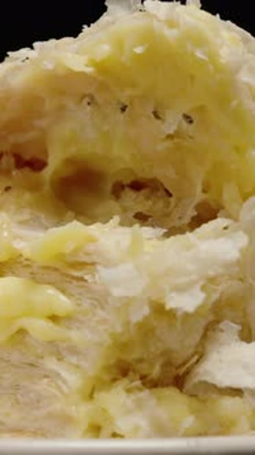 Vertical video. Lifting the Top Layer of Puff Pastry Cake with Custard Cream Using a Fork. Tea Time.