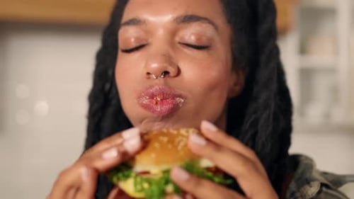 Closeup View of Delicious Juicy Hamburger in Hands of Black Woman Fast Food Young Adult African